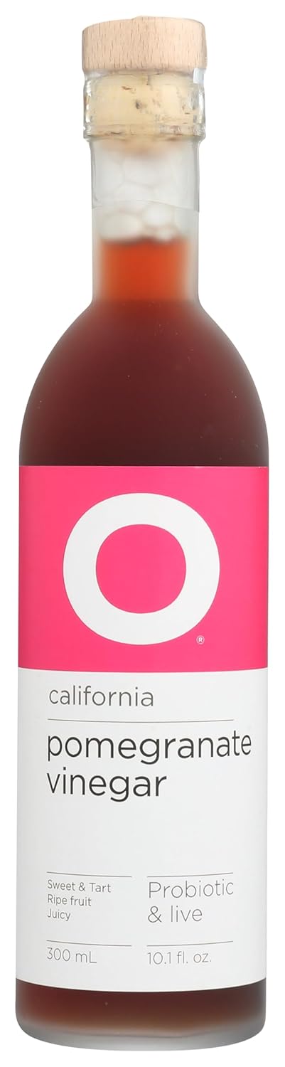 O Olive Oil fruit vinegar bottles displayed on a kitchen counter